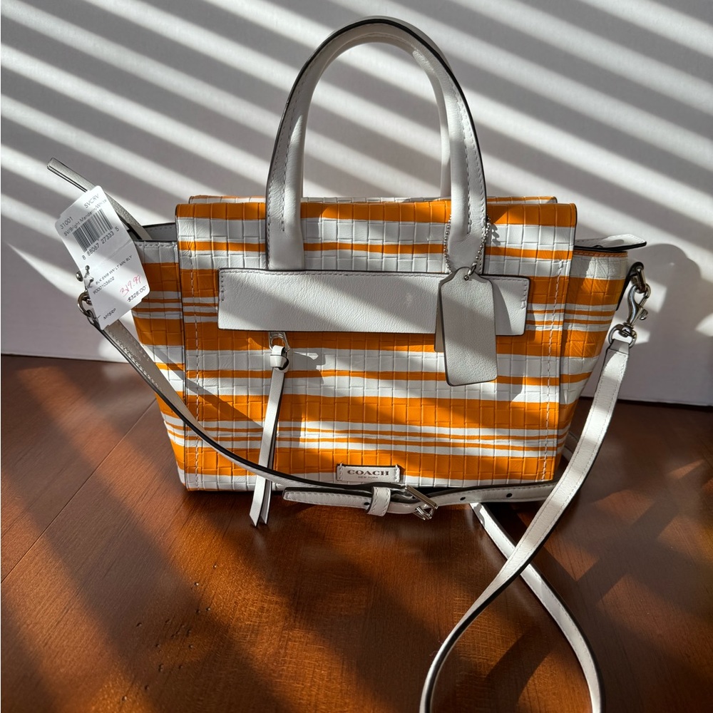 Authentic NWT Coach Purse in Mandarin/White stripes.